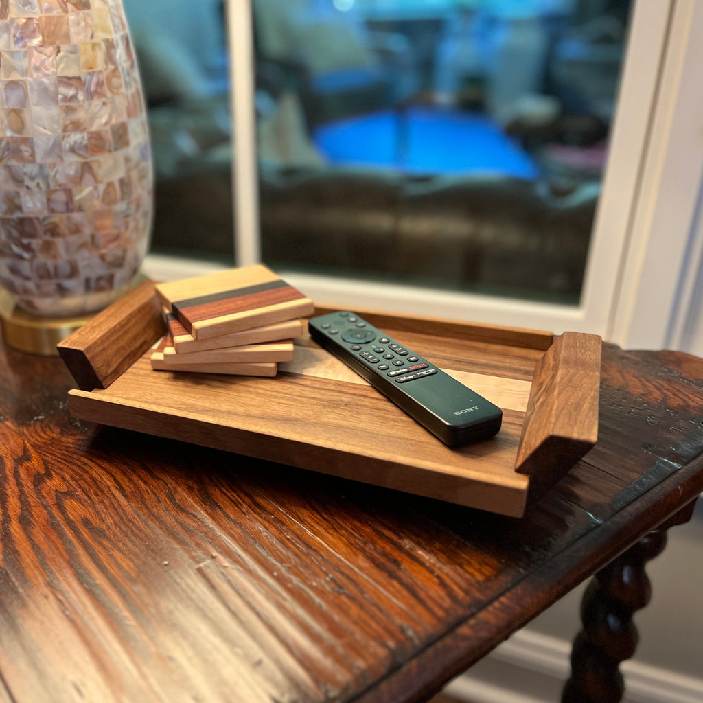 handcrafted walnut and maple wood valet tray. Choice of hardwoods and size. Image shows the valet tray on a side table holding coasters and a television remote.