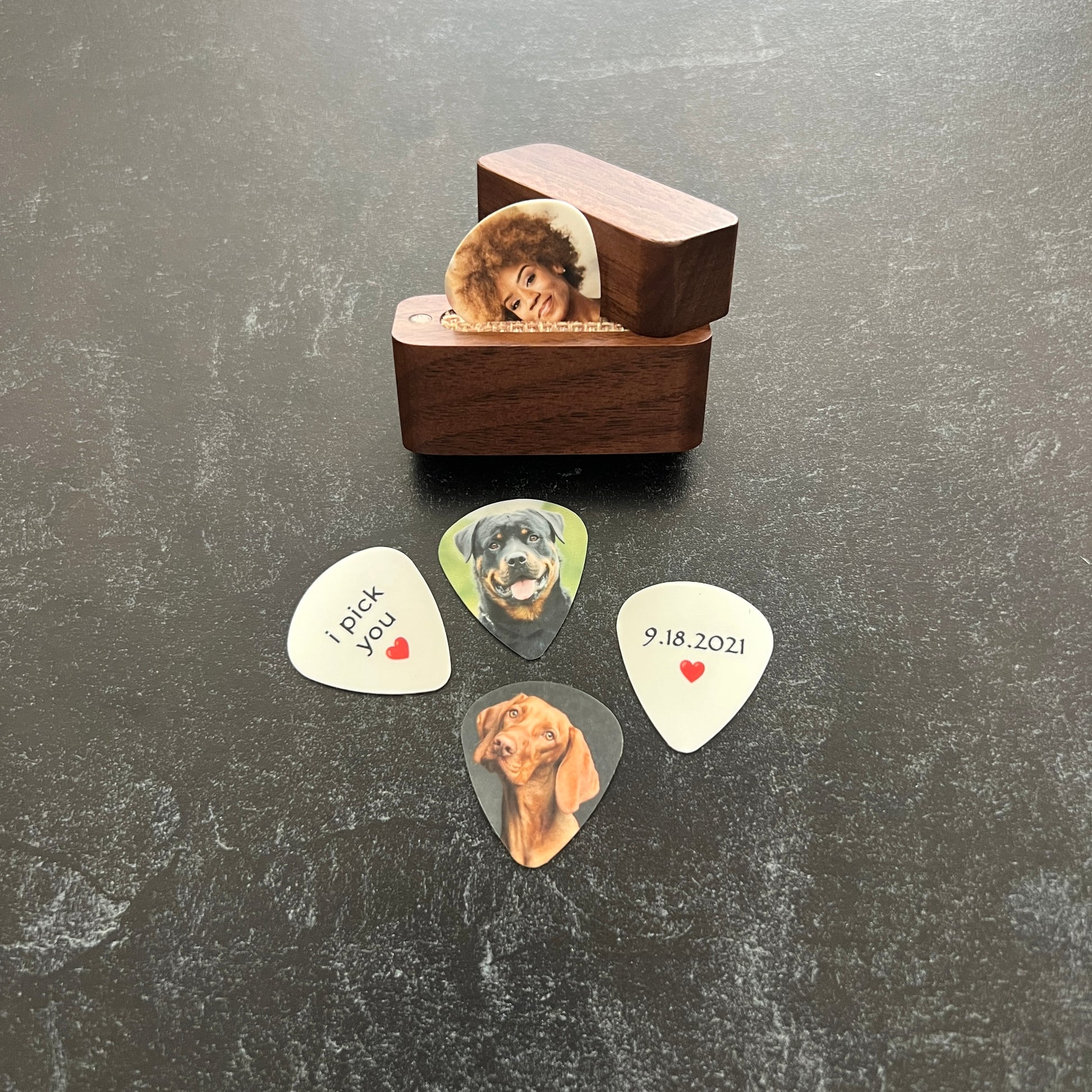 Custom color photo guitar picks with personalized image on front and custom text on back, made in South Carolina - shown with photo pick in magnetic wood box and i pick you and a red heart on the back