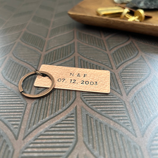 Personalized copper keychain with custom hand-stamped text, handcrafted and hammered in South Carolina