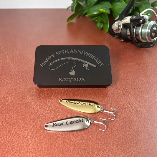 Personalized fishing lures with engraved text on a leather surface, accompanied by a custom engraved and designed black box.