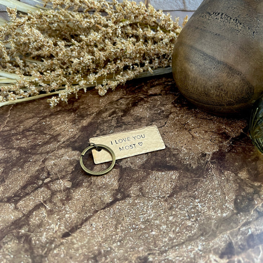 Personalized bronze keychain with custom hand-stamped text, handcrafted and hammered in South Carolina