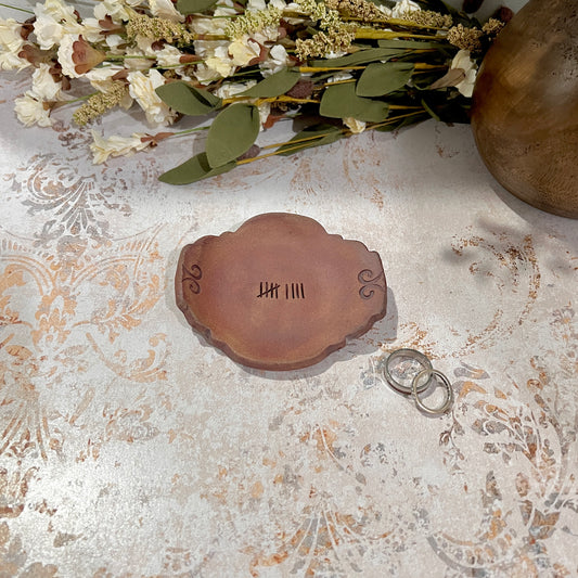 Handcrafted 9th anniversary pottery ring dish stamped with nine tally marks in hazelnut brown stoneware with rust iron oxide finish