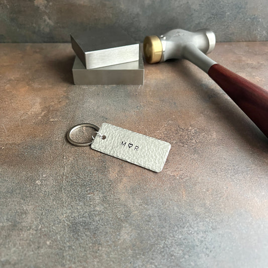 Personalized pewter keychain with custom hand-stamped text, handcrafted and hammered in South Carolina