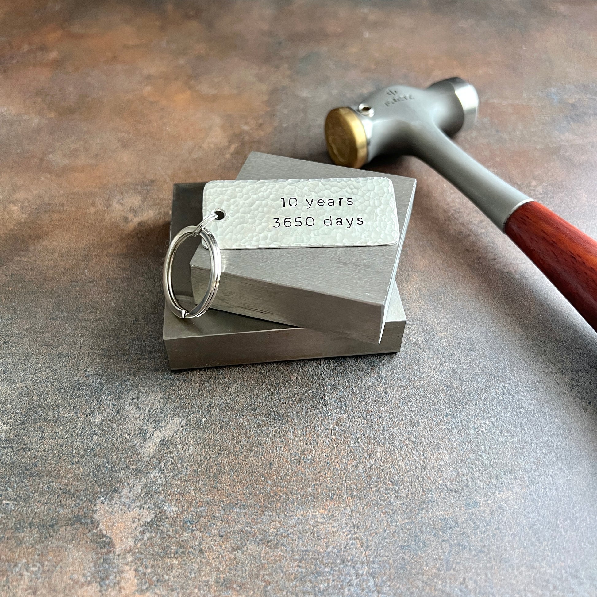 Personalized pewter keychain with custom hand-stamped text, handcrafted and hammered in South Carolina